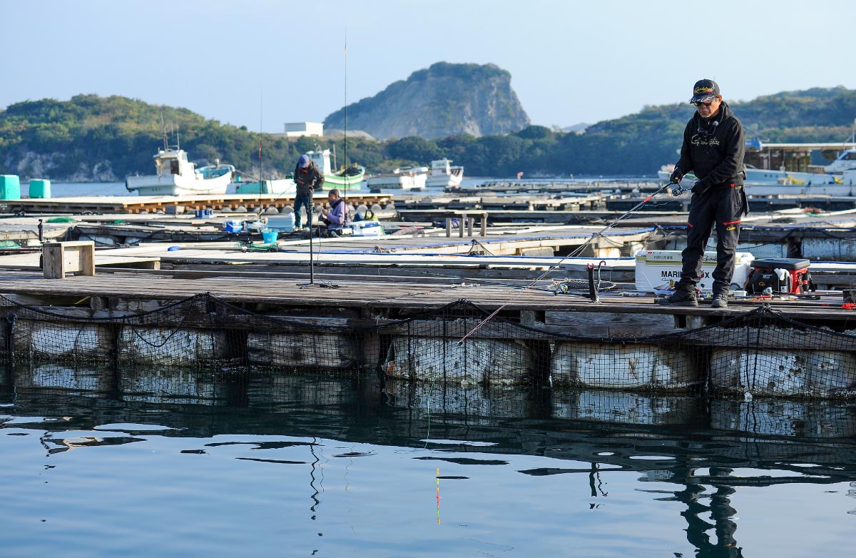 ウキ釣りをする沖長。ウキを見つめアタリを待っている。